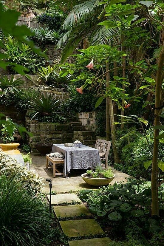 Lush leafy garden patio with a shaded outdoor dining table